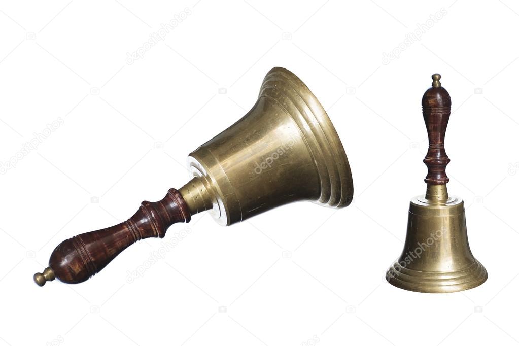 Old school bell or hand bell made of brass with wooden handle is