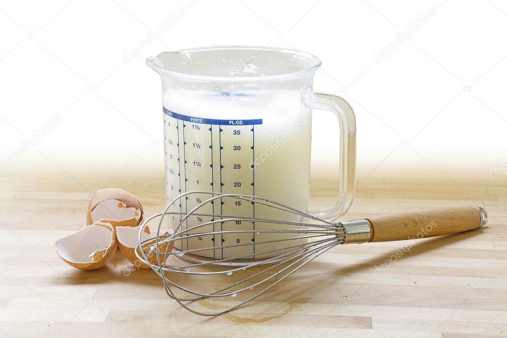 beaten stiff egg white in a plastic jug, hand whisk and empty eg