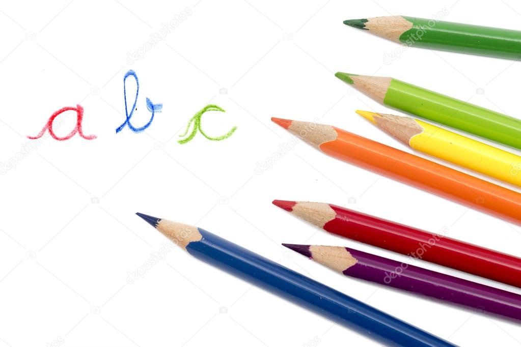 colored pencils and handwritten letters ABC isolated on white