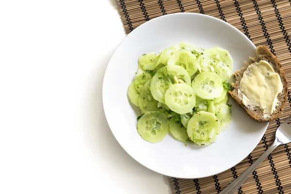Salad of cucumber with bread on a white plate — Stock Photo, Image