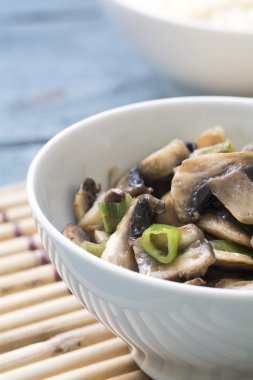 bir bambu ma üzerinde beyaz porselen kase mantar sebze tabağı