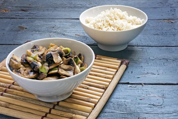 Mushroom vegetables and rice in bowls on a bamboo mat and rustic — Stock Image Mushroom vegetables and rice in bowls on a bamboo mat and rustic Royalty Free Stock Images