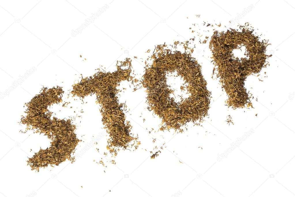 loose tobacco formed into the word STOP, isolated on white