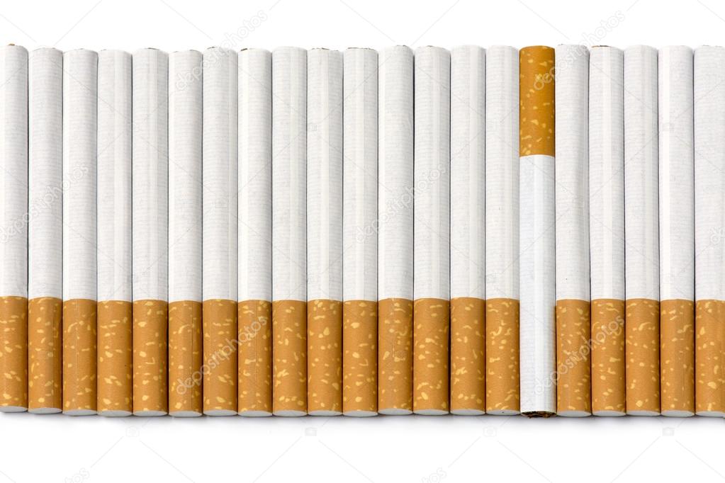 row of filter cigarettes, one is upside down isolated on white
