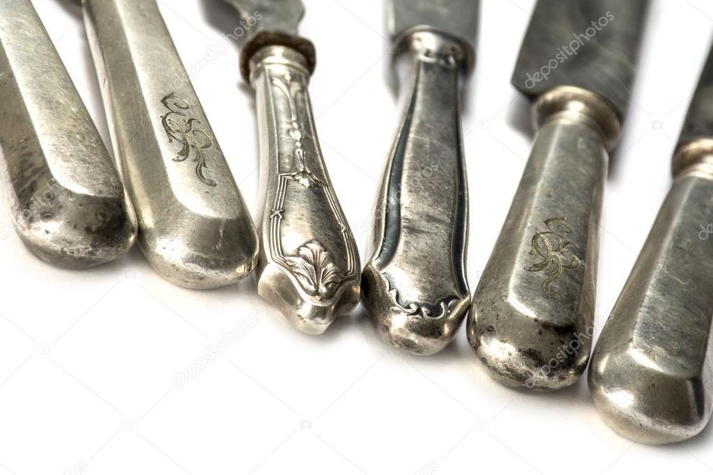 old knife handles made of silver of various cutlery, isolated on