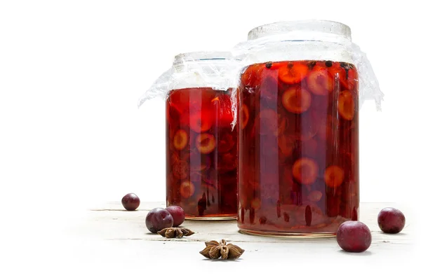 Preserved red fruits in two glass jars, isolated against white — Stock Photo, Image