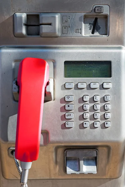 Public phone with a red handset — Stock Photo, Image