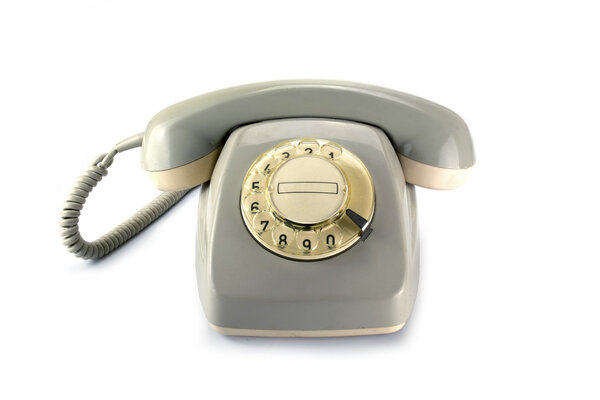 Винтажный роторный телефон, серый пожелтевший пластик на белой спинке
