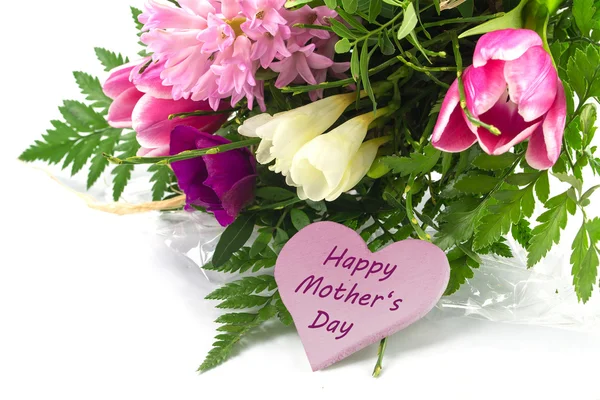 Flower bunch and a pink heart shape with text happy mother's day — Stock Photo, Image