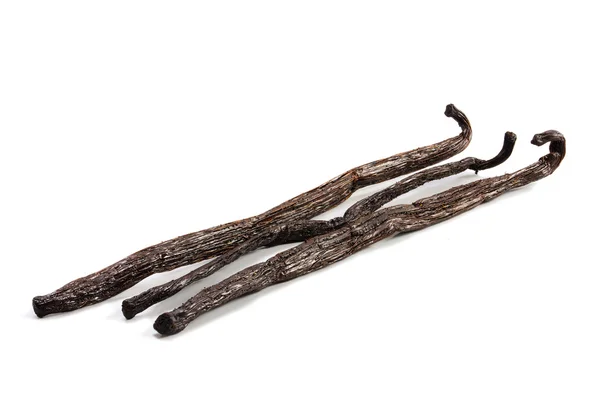 Three vanilla pods isolated with shadows on a white background — Stock Photo, Image