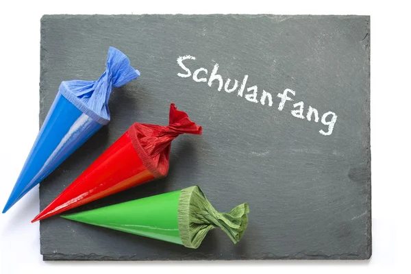 School cones on a  chartboard with german message schulanfang — Stock Photo, Image