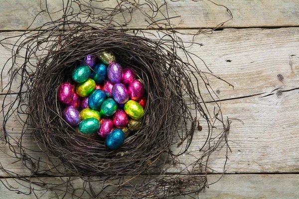 A pasztell színek, a rozsda-becsomagolt csoki tojás húsvéti fészek — Stock Fotó