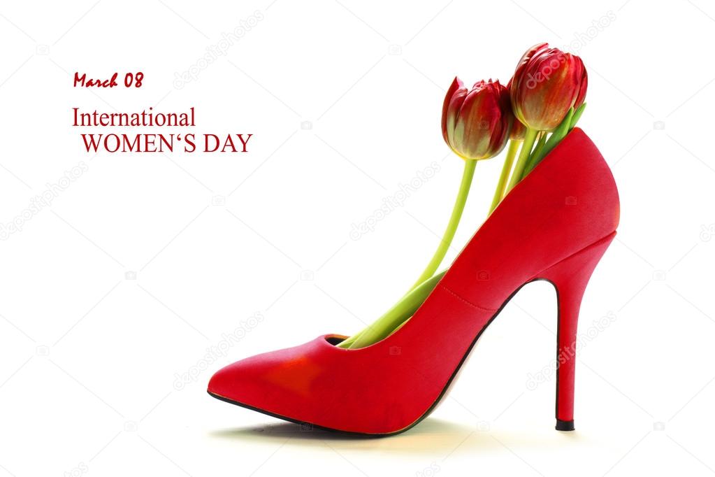 Ladies red high heel shoe with tulips inside, isolated on white, concept for female, love, valentines and womens day