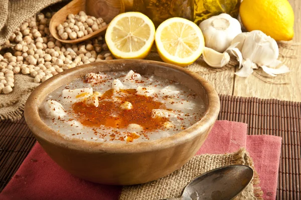 Turkish traditional tripe soup on rustic background with wooden table — Stock Image Turkish traditional tripe soup on rustic background with wooden table Stock Photo