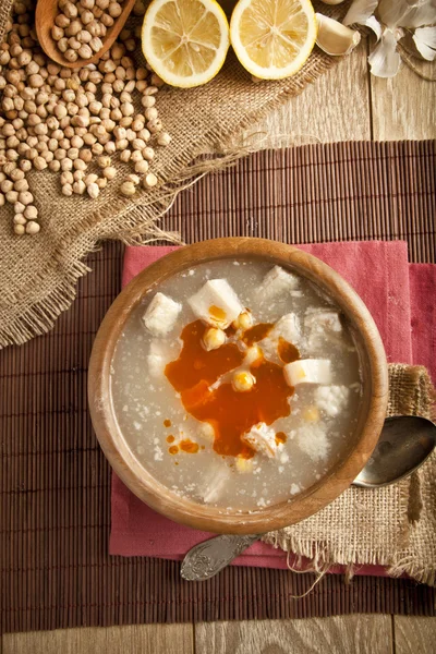 Turkish traditional tripe soup on rustic background with wooden table — Stock Image Turkish traditional tripe soup on rustic background with wooden table Royalty Free Stock Images