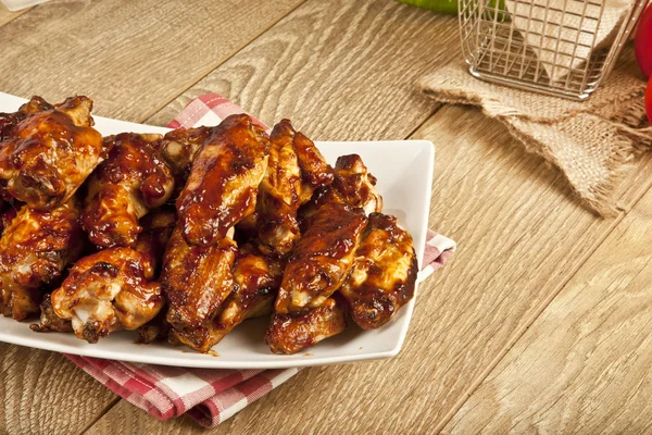 Buffalo BBQ Chicken Wings on wooden table — Stock Photo, Image