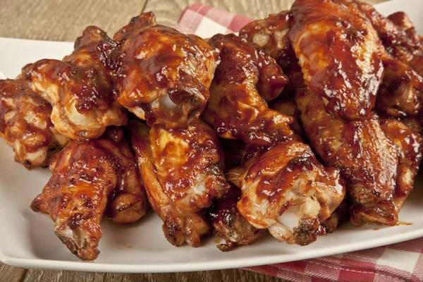 Buffalo BBQ Chicken Wings on wooden table — Stock Photo, Image