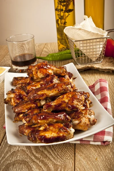 Buffalo BBQ Chicken Wings on wooden table — Stock Photo, Image