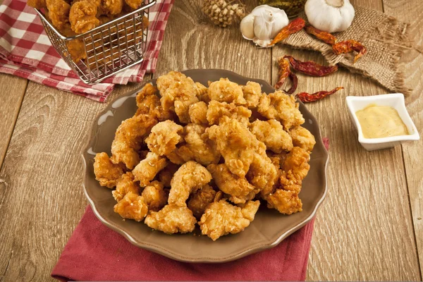 Chicken fry pop with honey mustard on the wooden table