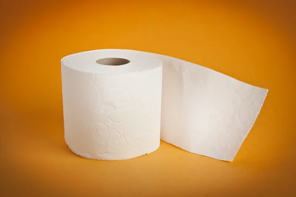 Simple toilet paper on yellow background — Stock Photo, Image