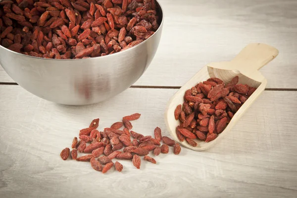 Wooden spoon with goji berries on the table closeup — Stock Photo, Image