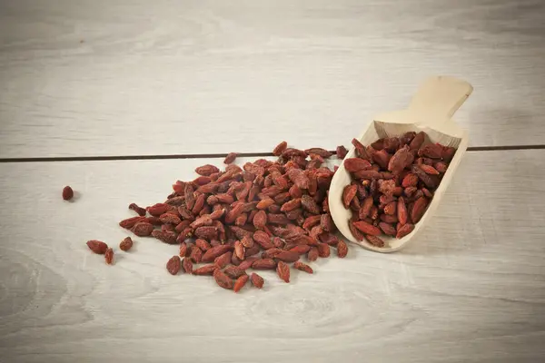 Wooden spoon with goji berries on the table closeup — Stock Photo, Image