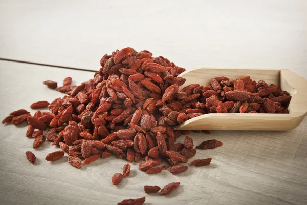 Wooden spoon with goji berries on the table closeup — Stock Photo, Image