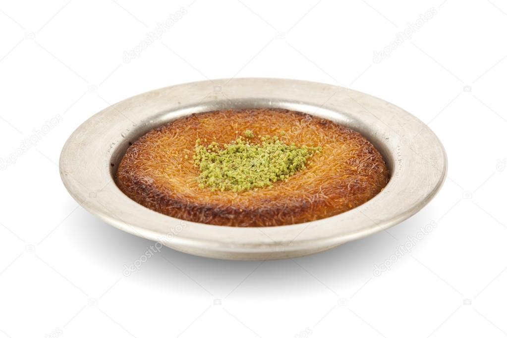 Delicious traditional Turkish kunefe with pistachio on it. Served hot and with syrup