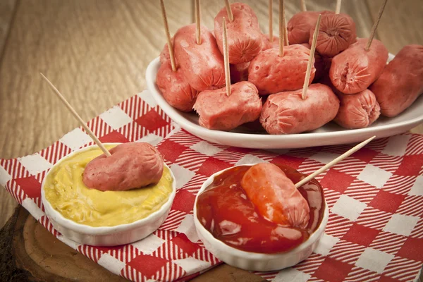 Mini Salamis Sausage in a small bowl on wooden background — Stock Photo, Image