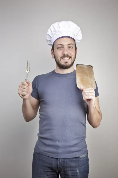 A male chef isolated over grey gradient background Stock Picture