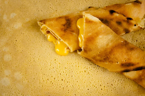 Pancake crepe with cheese on a hot stove — Stock Photo, Image