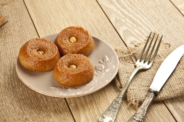 Turkish Ramadan sweet - Sekerpare with wooden background — Stock Photo, Image