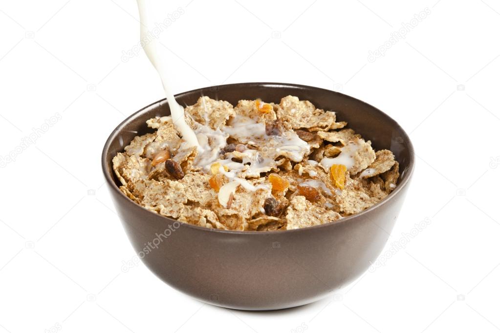 Bowl of sugar-coated corn flakes and spoon wooden background