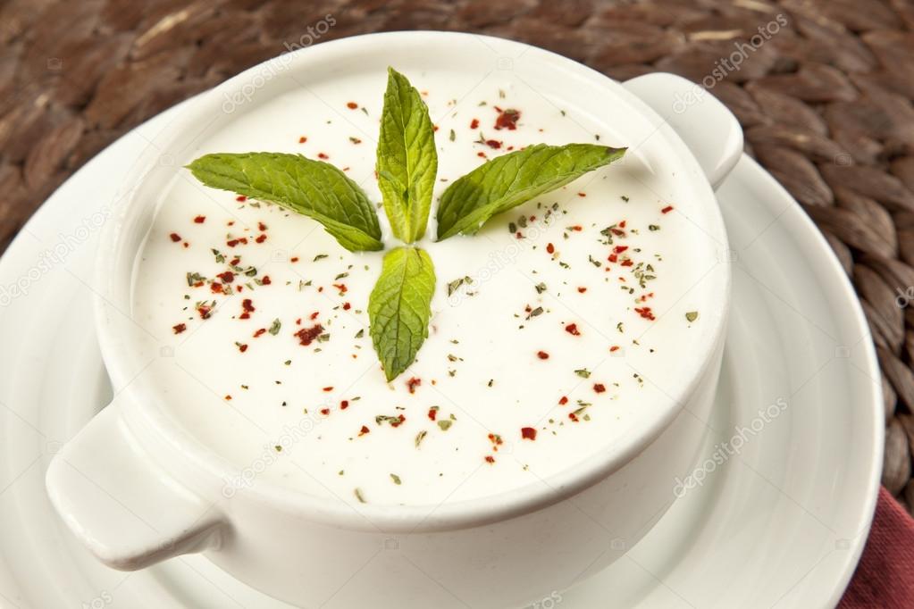 Cold soup with cucumbers, yogurt and fresh herbs on the table