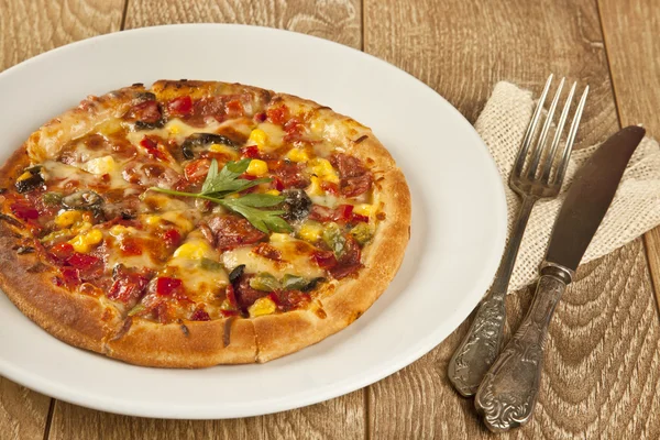 Pizza italiana entera sobre mesa de madera con ingredientes —  Fotos de Stock