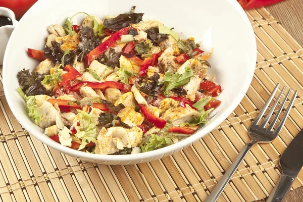 Caesar salad with chicken in white bowl on dark rustic table — Stock Photo, Image