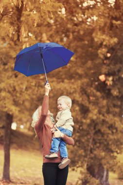 Mutlu aile anne ve çocuk sonbahar günü şemsiye ile