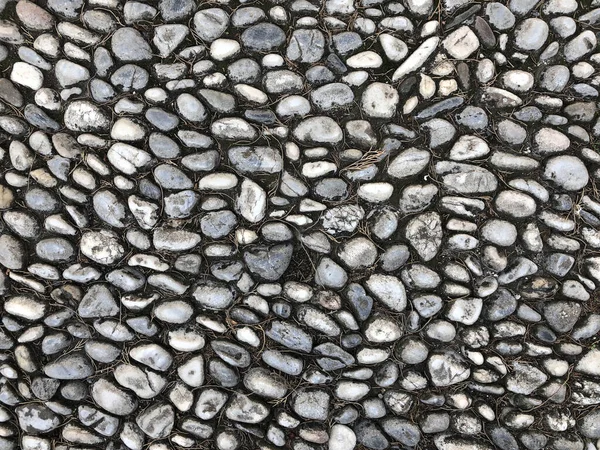 关闭灰色小卵石背景 石头作为铺路石 — 图库照片