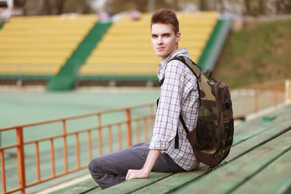 Handsome young smiling man with backpack — Stock Photo, Image