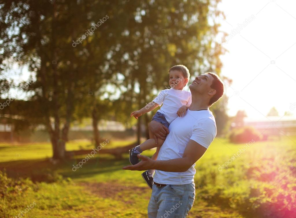 Happy father and son having fun, enjoying sunny summer day