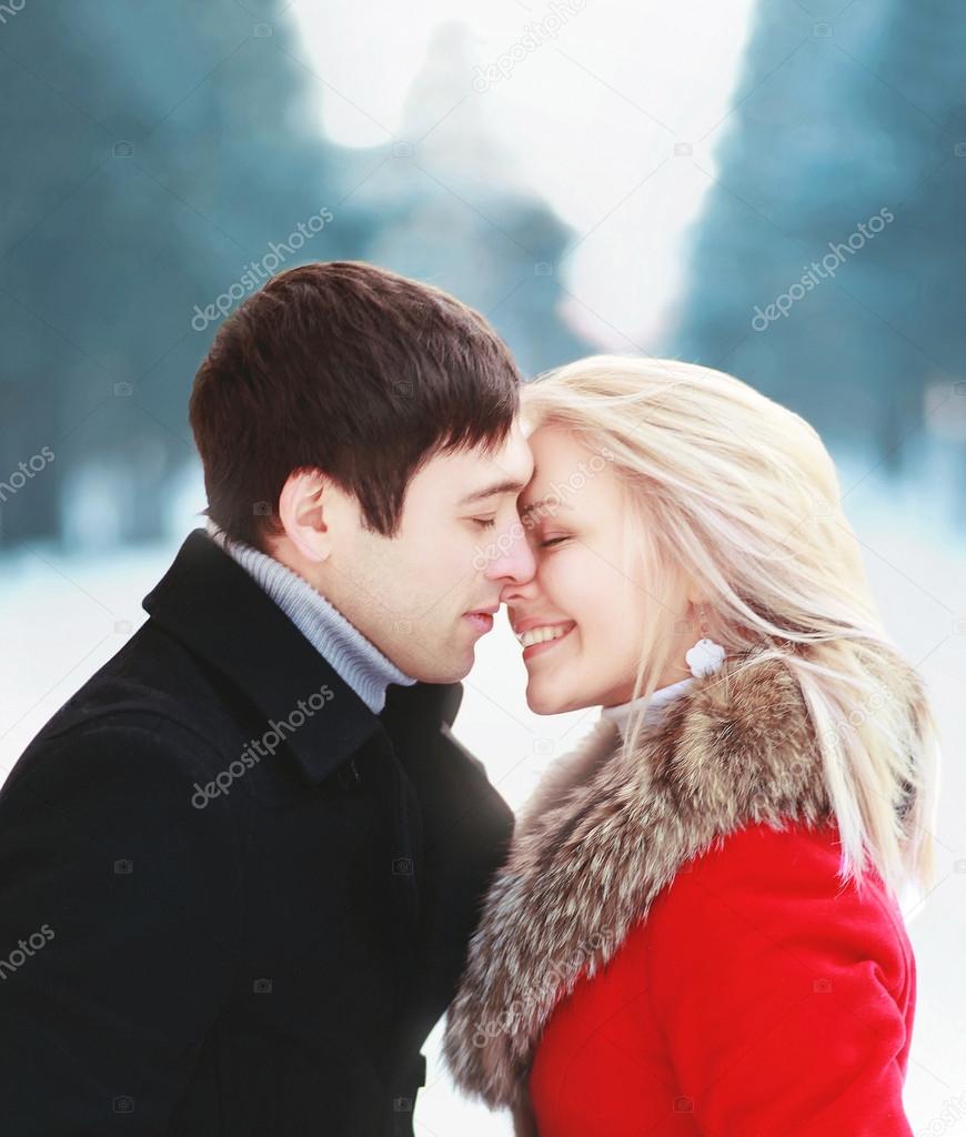 Beautiful happy sensual couple in love in cold sunny winter day.