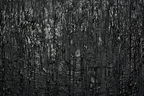 Textur einer Wand mit fließender Farbe, schwarzem Hintergrund — Stockfoto