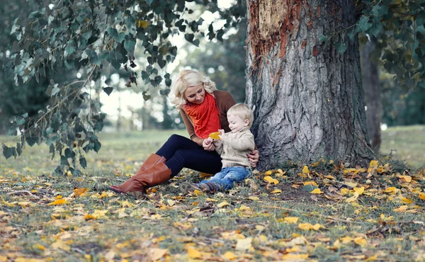 Happy mother and baby in autumn — Stock Photo, Image