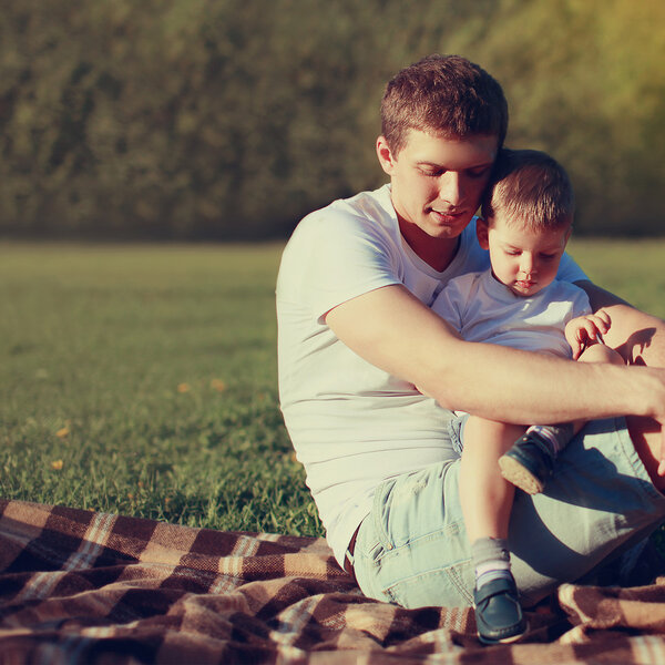 Lifestyle photo lovely father and son together resting outdoors 