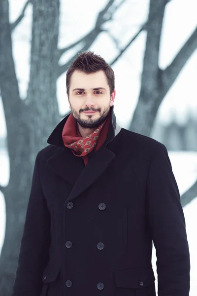 Handsome man in black coat outdoors — Stock Photo, Image