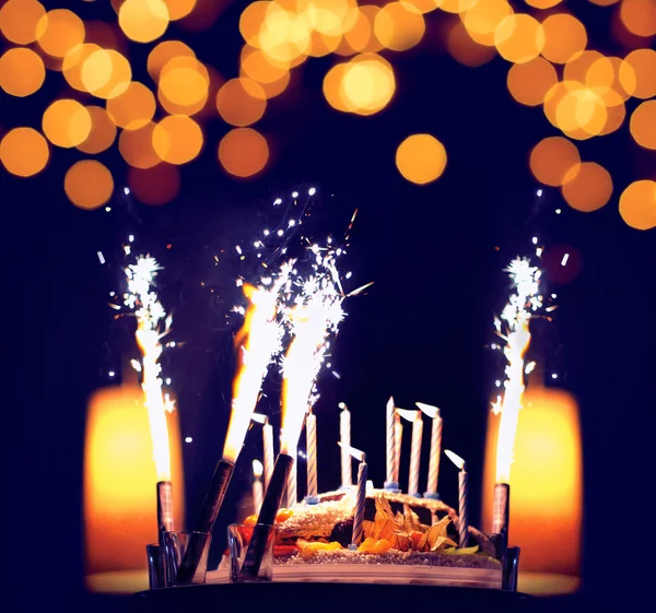 Celebration, birthday cake with candles, bright lights bokeh