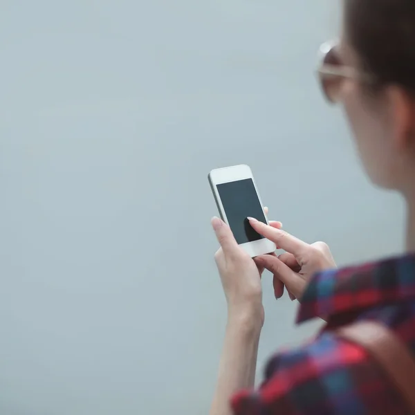 Fashion photo girl using smartphone outdoors, female hands point Royalty Free Stock Photos