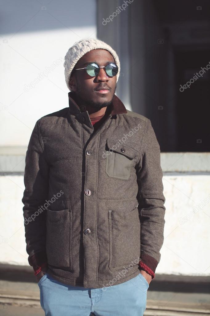 Fashion stylish young african man wearing a sunglasses and jacke