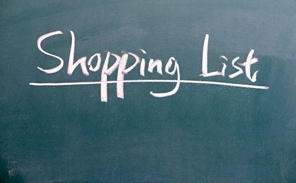 Lista de compras escrita com giz branco em um quadro negro — Fotografia de Stock
