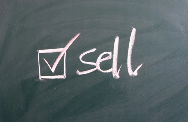 Sell and button on blackboard — Stock Photo, Image